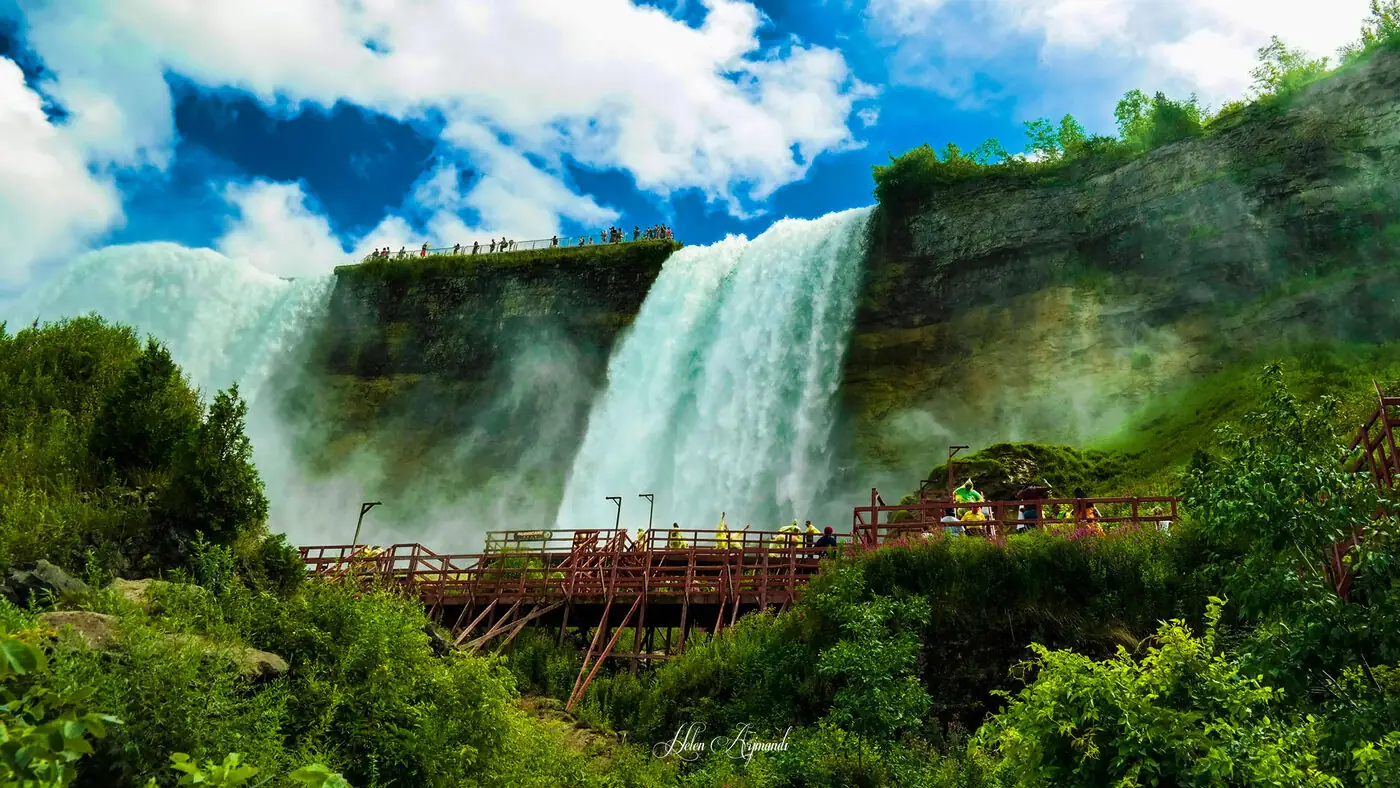 Niagara's American Falls seen from the boardwalk below, mist rising.